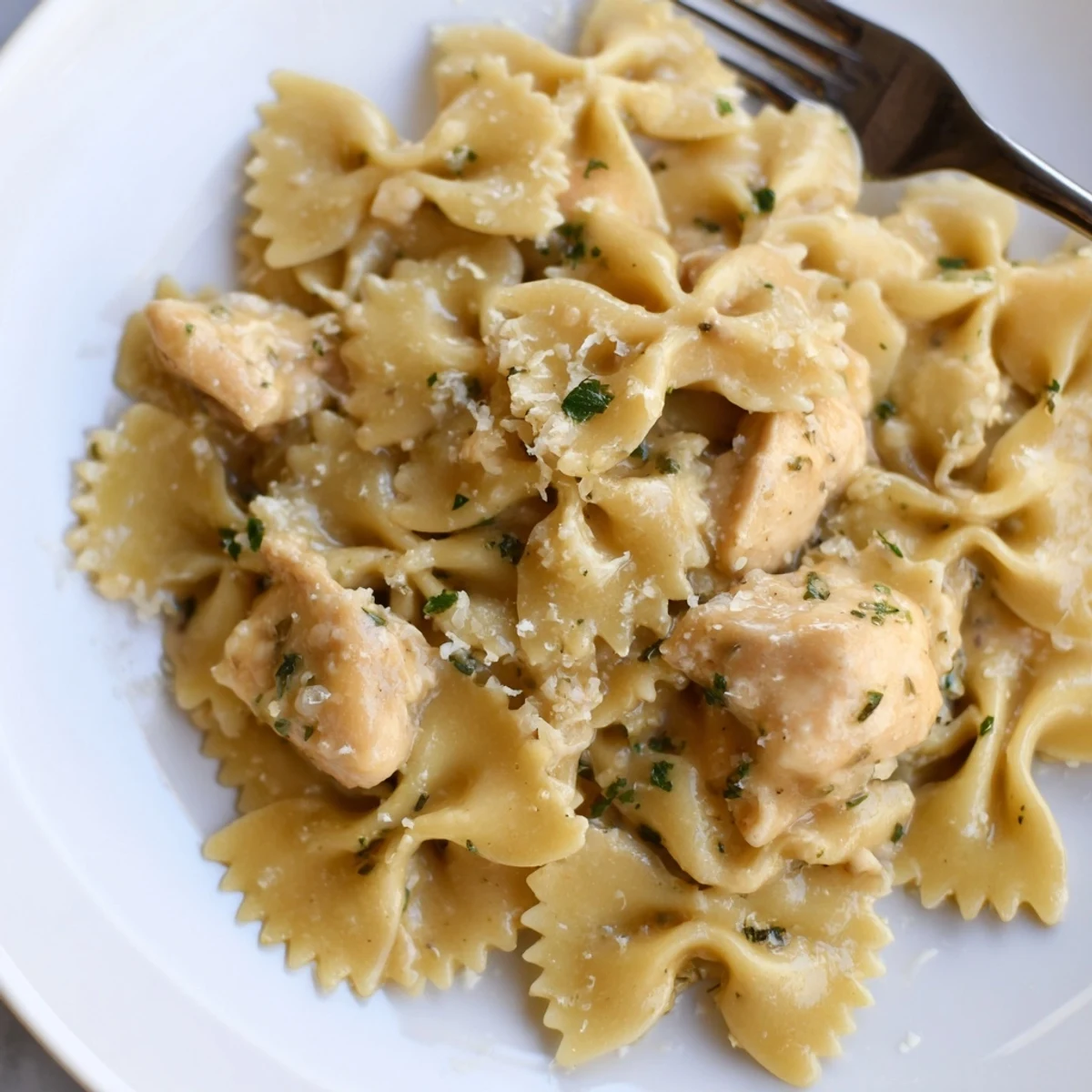 Mozzarella Garlic Butter Chicken Bowties served in a creamy garlic sauce, garnished with parsley.  