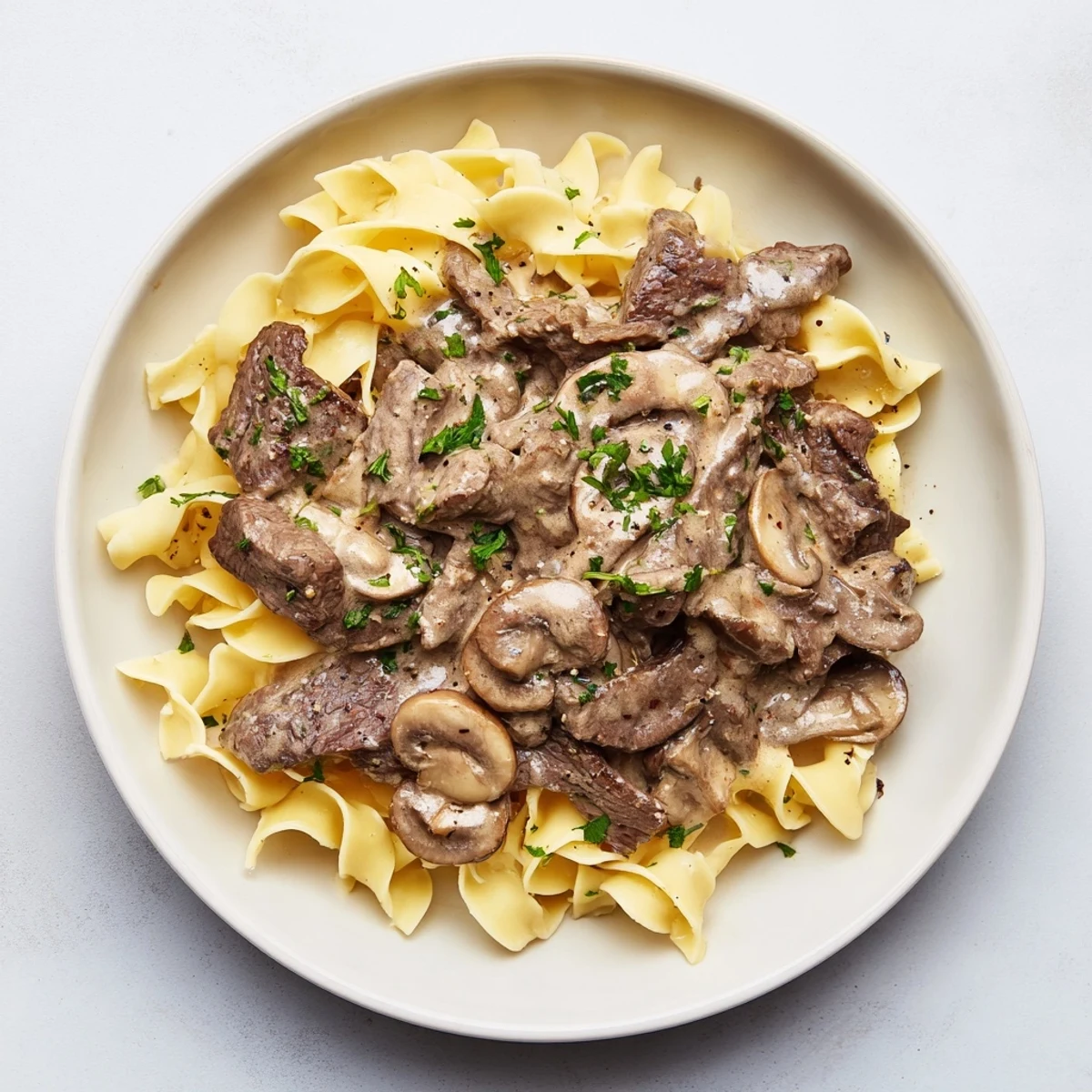 Homemade Creamy Mushroom Beef Stroganoff with golden-brown mushrooms, showcasing a delicious, savory meal.