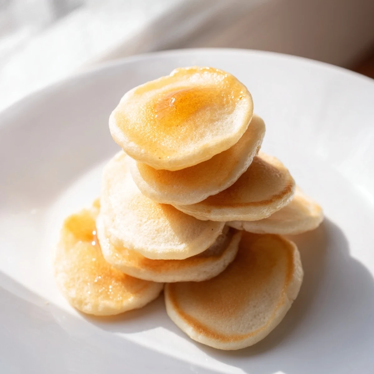 Golden and fluffy pancake cereal, perfect mini pancakes ready to eat with syrup and milk.