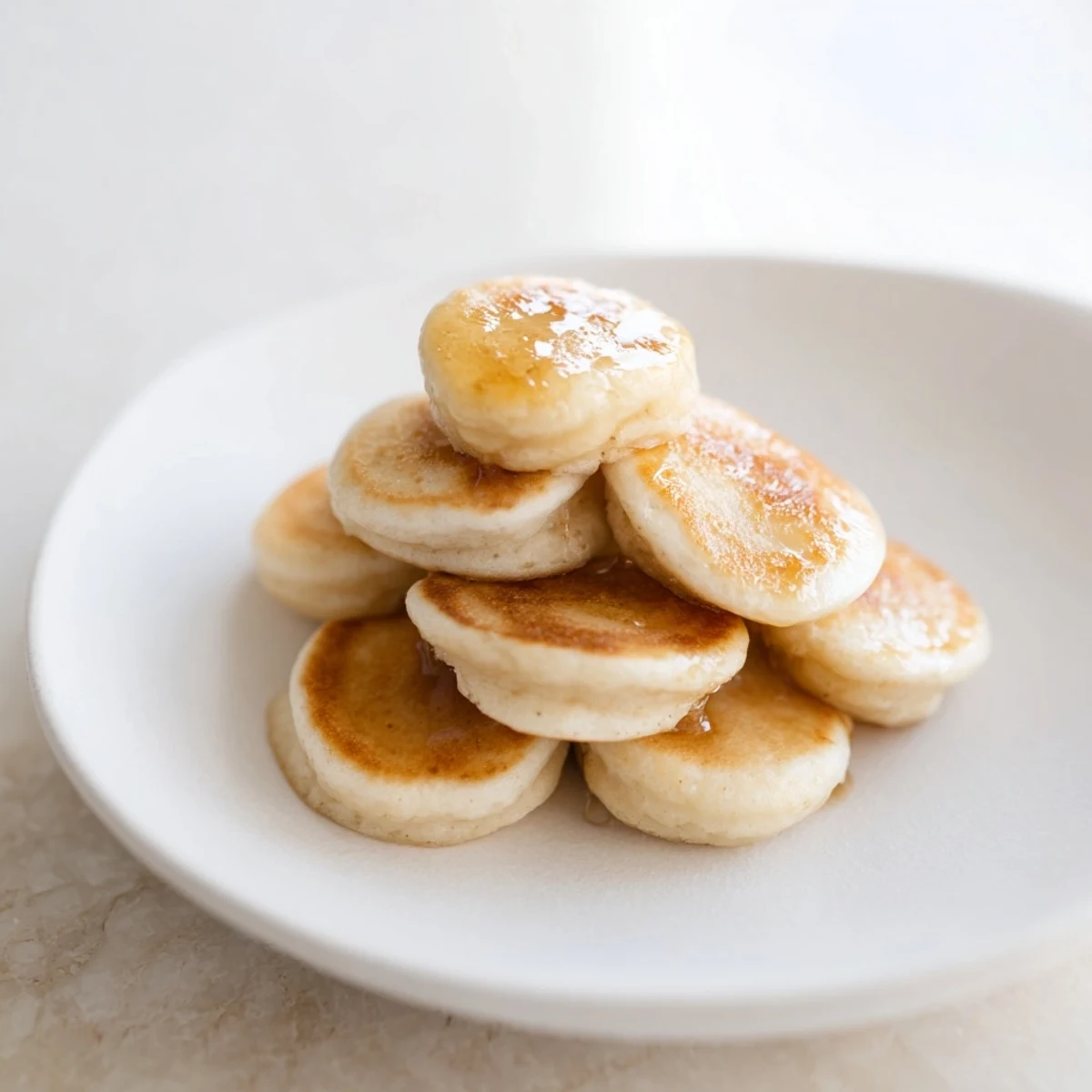 A colorful bowl of pancake cereal, with tiny, golden pancakes ready to be enjoyed as breakfast.