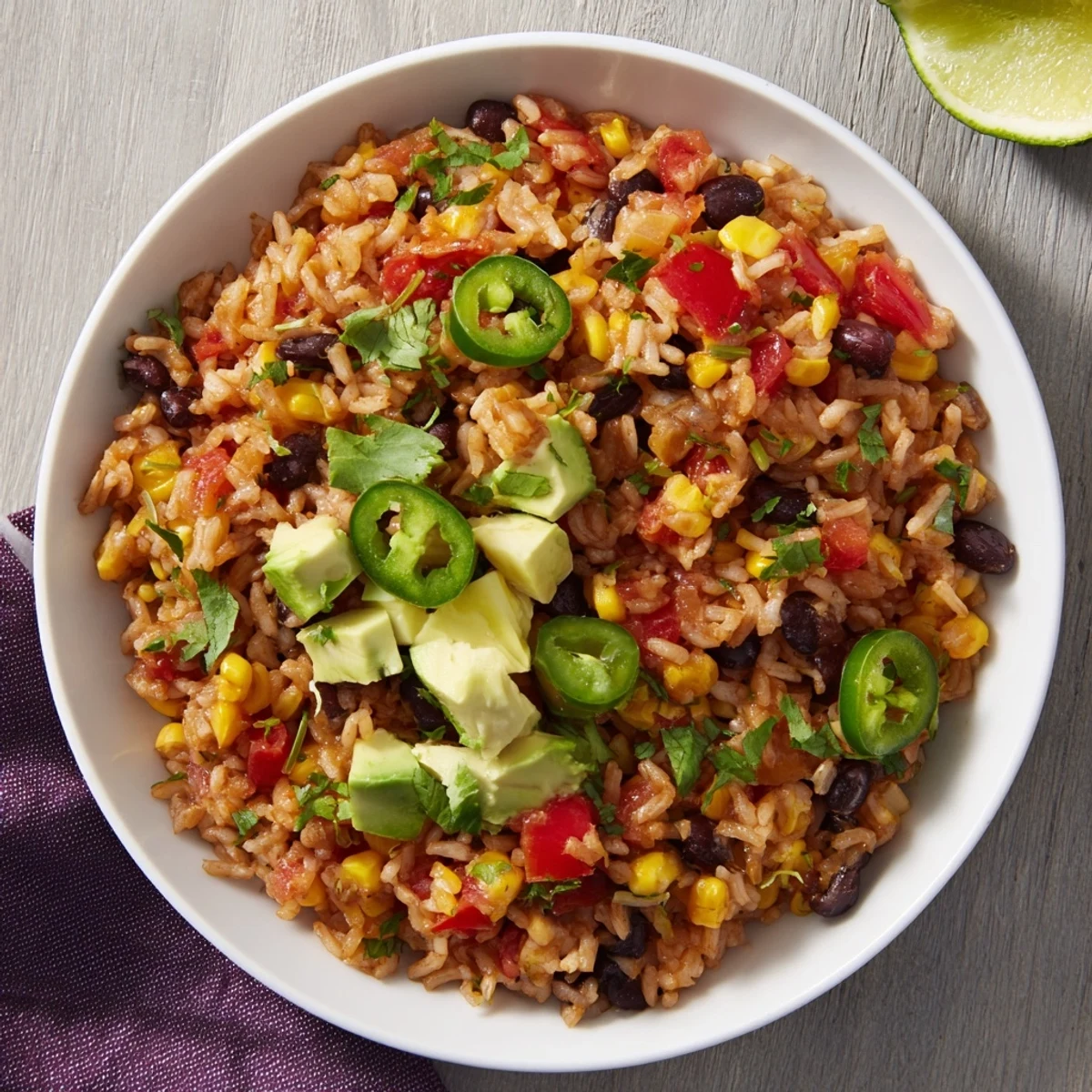 Steaming bowl of One-Pot Mexican Rice & Beans, with fresh cilantro and a squeeze of lime.