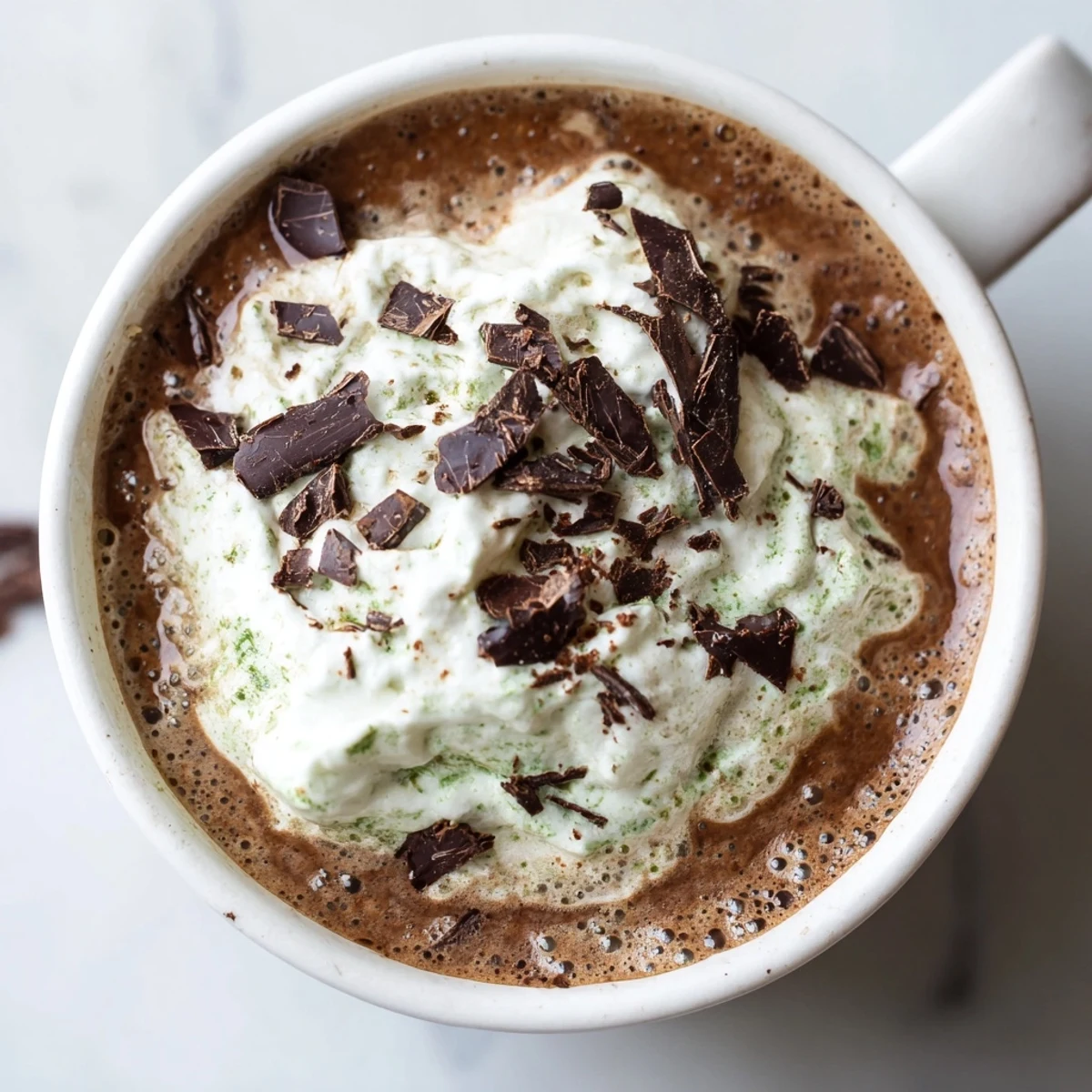 Enjoy a vibrant, frothy Collagen Peppermint Mocha Matcha Latte, perfect for a dairy-free morning treat.