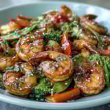 A colorful shrimp stir-fry with crisp vegetables in a savory garlic-ginger sauce, served over steamed rice.  