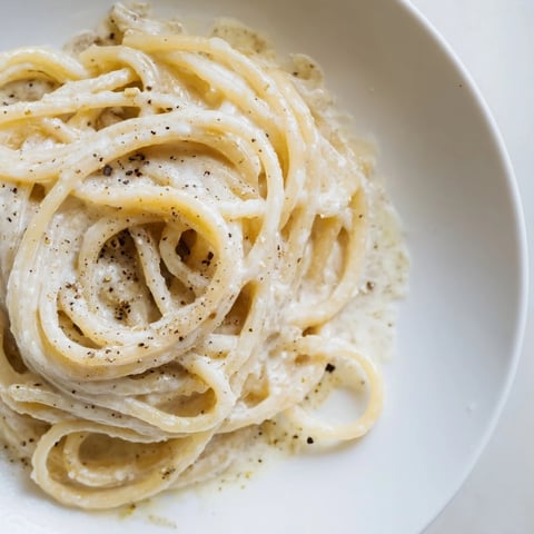 Creamy Lazy Girl Three-Ingredient Pasta shimmering with melted butter and Parmesan, ready to eat.