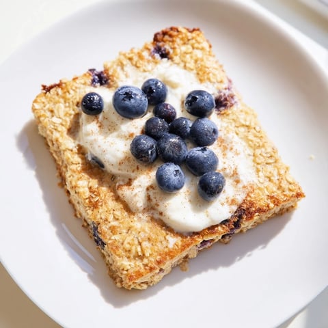 Fluffy Protein Pancake Oats, baked until golden, with juicy blueberries ready to be savored.
