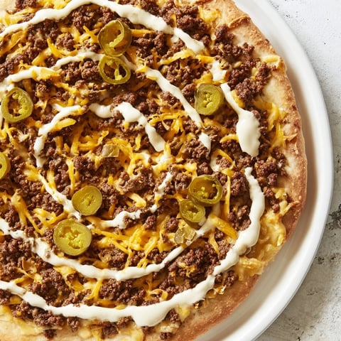 Ground Beef Taco Pizza, a delicious and cheesy pizza bursting with savory taco flavors.