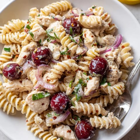 Homemade Cherry Jalape&amp;ntilde;o Chicken Pasta with juicy cherries, inviting aroma, ready to eat.