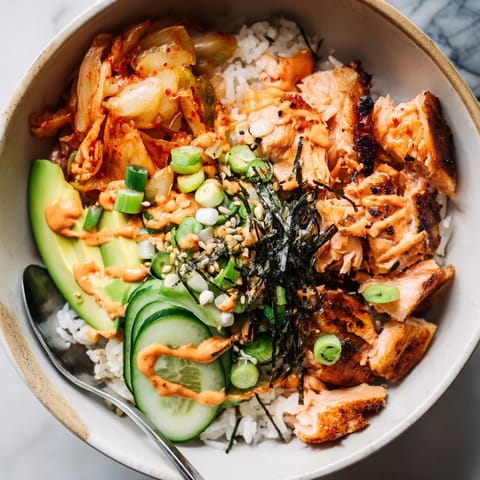 Deliciously vibrant Crispy Salmon Rice Bowl featuring flaky salmon and crunchy garlic.  