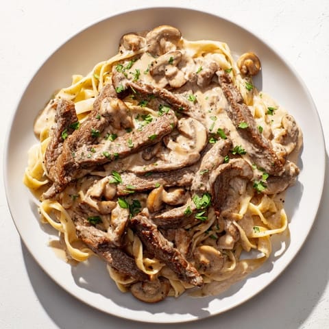 Rich Creamy Mushroom Beef Stroganoff with parsley garnish, ready to serve as a hearty dinner.