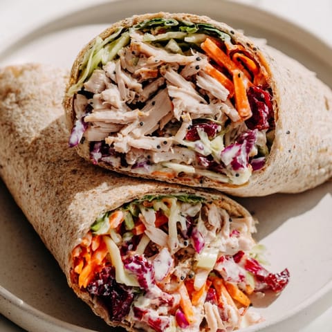 Freshly assembled Cranberry Apple Slaw Turkey Wraps, bursting with vibrant colors and creamy dressing.
