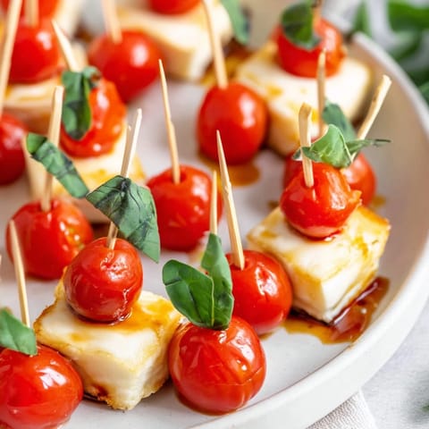 These savory star-shaped Caprese skewers look beautiful, drizzled with balsamic glaze and olive oil.