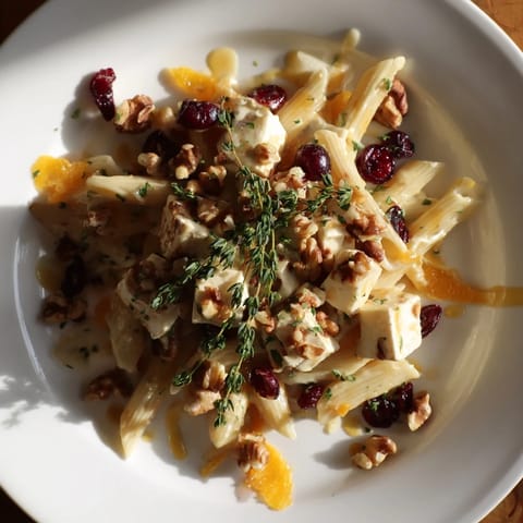 Golden-topped baked brie & cranberry pasta, a vegetarian main course with bubbling cheese and fruit.
