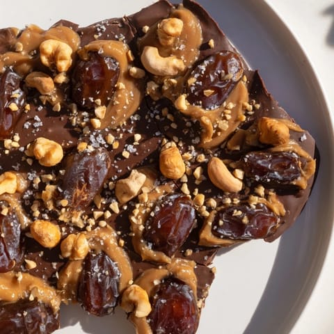 Craving something sweet? This Date Bark Snickers-Style shows off layers of delightful dessert.