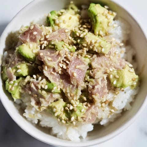 Colorful Tuna Avocado Rice Bowl served with diced scallions and toasted sesame seeds, perfect for a quick, nourishing weeknight dinner for two.