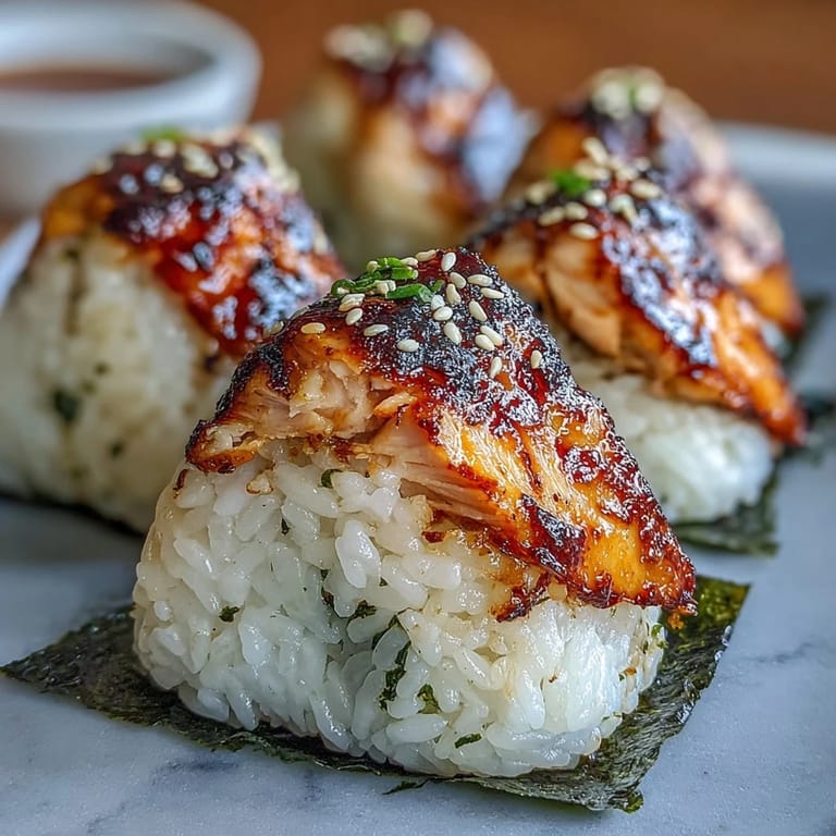 Warm onigiri filled with tender grilled salmon, wrapped in nori, and lightly crisped for a satisfying handheld bite.  